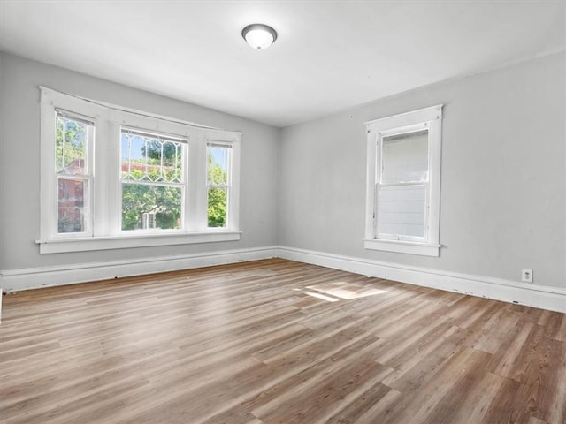 empty room featuring wood finished floors and baseboards