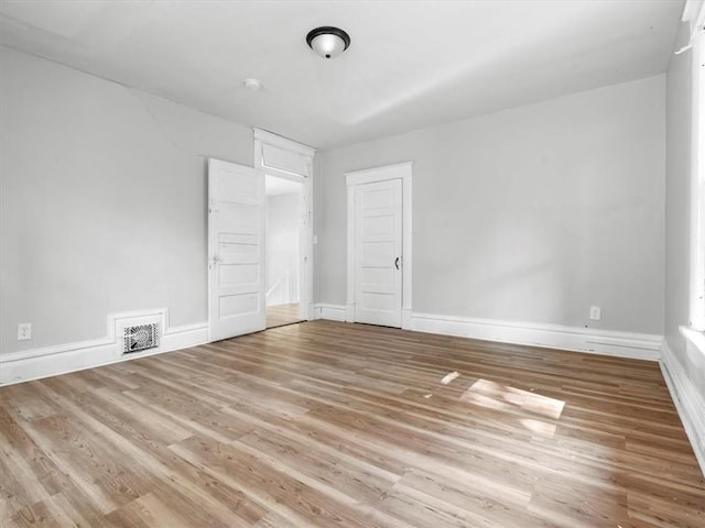 unfurnished bedroom with wood finished floors and baseboards