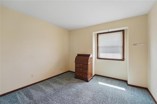 carpeted spare room with baseboards