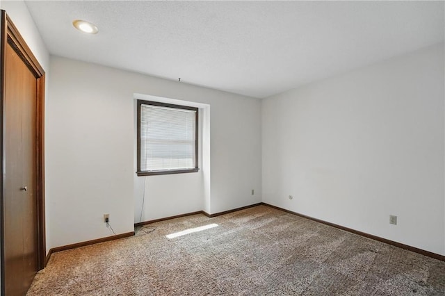 unfurnished bedroom featuring carpet, a closet, and baseboards