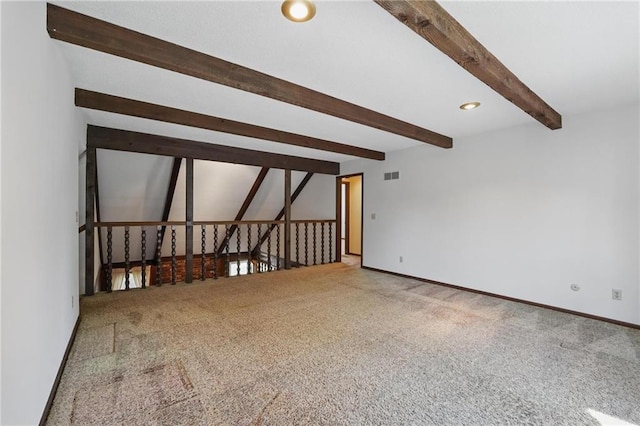 spare room with beamed ceiling, carpet flooring, and baseboards