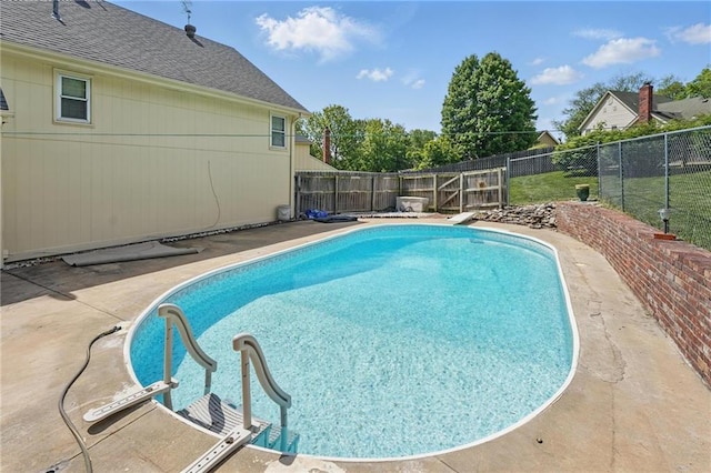 view of swimming pool featuring a fenced backyard and a patio