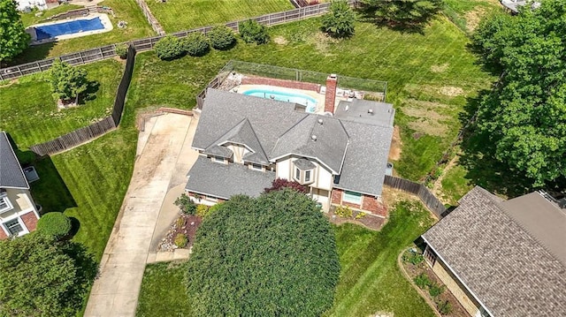 view of subject property with a pool