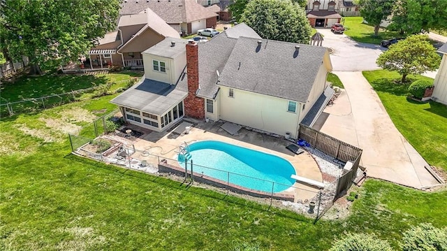 view of swimming pool with a patio area, a diving board, and a residential view