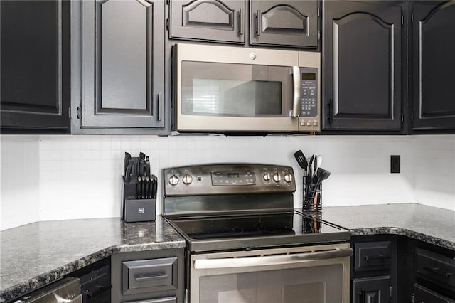 222 Prairie Ln, Wellsville, KS 66092 - kitchen with stainless steel microwave, range with electric cooktop, backsplash, and dark cabinets