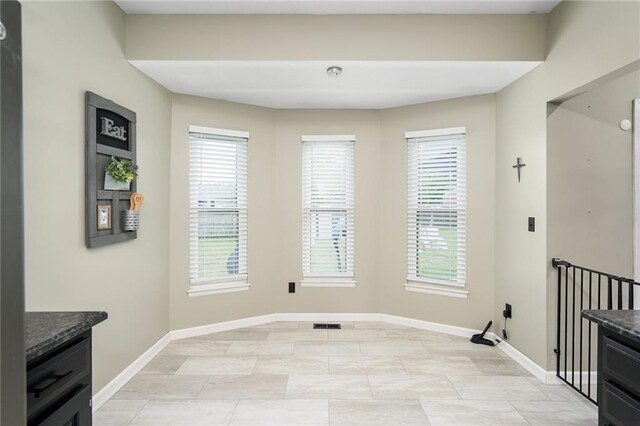 222 Prairie Ln, Wellsville, KS 66092 - unfurnished dining area featuring baseboards and plenty of natural light