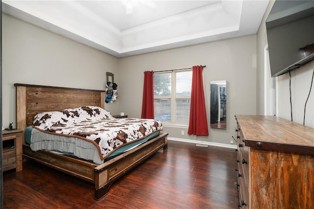 222 Prairie Ln, Wellsville, KS 66092 - bedroom featuring a raised ceiling, dark wood-style flooring, baseboards, and ceiling fan