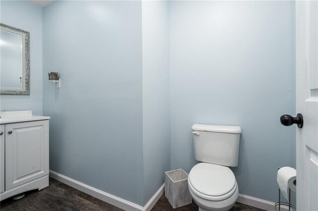 222 Prairie Ln, Wellsville, KS 66092 - half bathroom with vanity, baseboards, and toilet