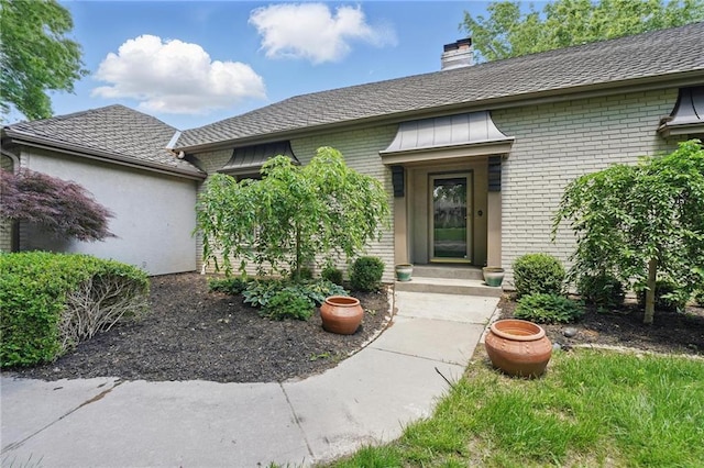 11203 Cedar St, Leawood, KS 66211 - property entrance with brick siding and a chimney
