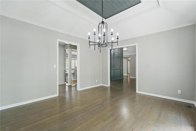 11203 Cedar St, Leawood, KS 66211 - unfurnished room with a chandelier, baseboards, dark wood-type flooring, a barn door, and crown molding