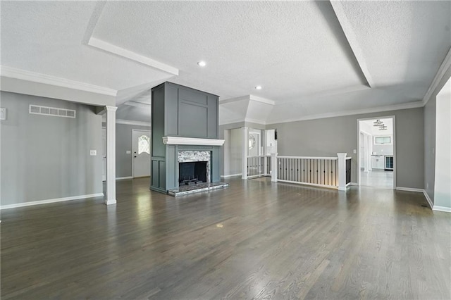 11203 Cedar St, Leawood, KS 66211 - unfurnished living room with a textured ceiling, baseboards, dark wood-type flooring, ornamental molding, and recessed lighting