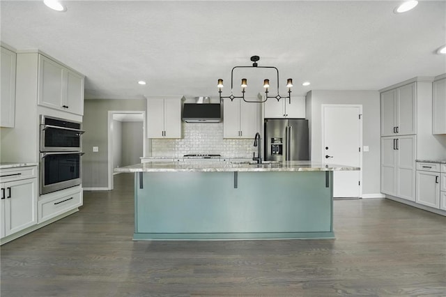 11203 Cedar St, Leawood, KS 66211 - kitchen with appliances with stainless steel finishes, ventilation hood, a sink, dark wood-style flooring, and baseboards