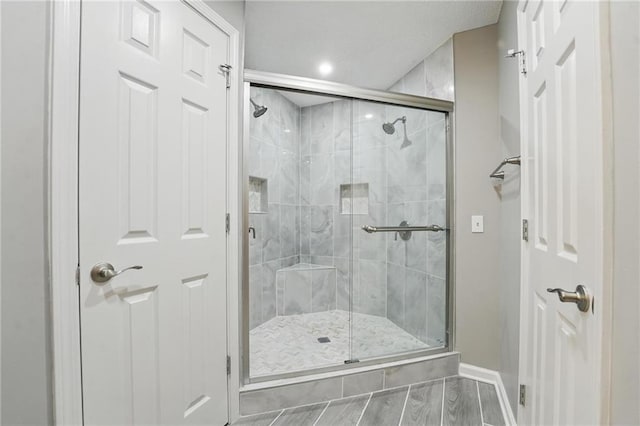 11203 Cedar St, Leawood, KS 66211 - bathroom featuring a shower stall, baseboards, wood finished floors, and recessed lighting