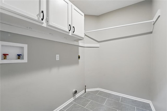 11203 Cedar St, Leawood, KS 66211 - washroom with cabinet space, hookup for an electric dryer, baseboards, hookup for a washing machine, and dark tile patterned floors