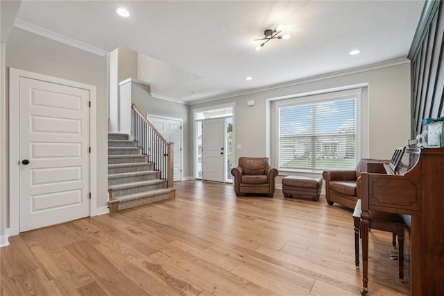 4813 NE Jamestown Dr, Lees Summit, MO 64064 - entrance foyer with crown molding, stairway, light wood-style floors, and recessed lighting