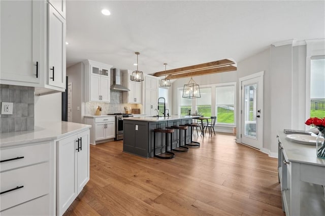 4813 NE Jamestown Dr, Lees Summit, MO 64064 - kitchen featuring stainless steel range oven, backsplash, wood finished floors, white cabinets, and recessed lighting