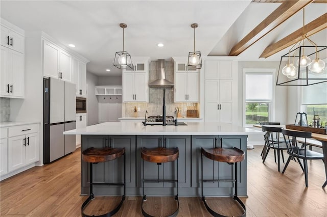 4813 NE Jamestown Dr, Lees Summit, MO 64064 - kitchen with freestanding refrigerator, wall chimney exhaust hood, black microwave, backsplash, and white cabinetry