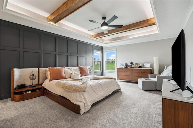 4813 NE Jamestown Dr, Lees Summit, MO 64064 - bedroom with a decorative wall, light colored carpet, a tray ceiling, beam ceiling, and ceiling fan