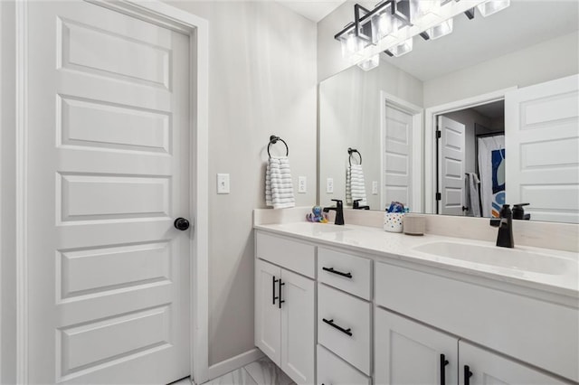 4813 NE Jamestown Dr, Lees Summit, MO 64064 - bathroom featuring double vanity and marble look tile flooring