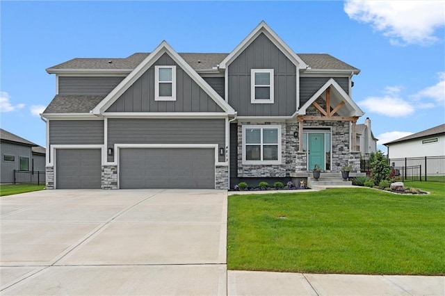 4813 NE Jamestown Dr, Lees Summit, MO 64064 - craftsman house featuring an attached garage, stone siding, board and batten siding, and driveway