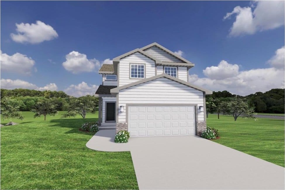 traditional-style home featuring a front yard, driveway, and a garage