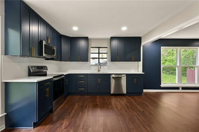 7826 Haskell Dr, Kansas City, KS 66109 - kitchen featuring stainless steel appliances, dark wood-style flooring, a sink, light countertops, and recessed lighting