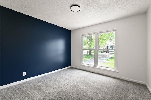 7826 Haskell Dr, Kansas City, KS 66109 - carpeted empty room featuring a textured ceiling and baseboards