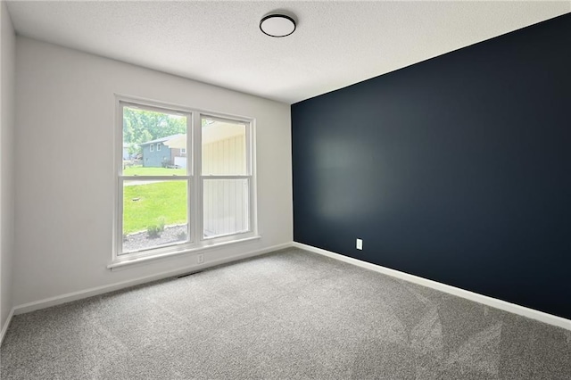 7826 Haskell Dr, Kansas City, KS 66109 - carpeted spare room featuring baseboards and a textured ceiling