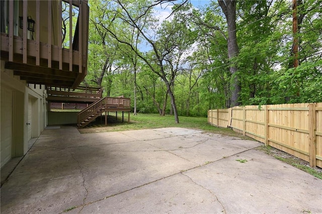 7826 Haskell Dr, Kansas City, KS 66109 - view of patio featuring stairs, fence, a wooden deck, and a wooded view
