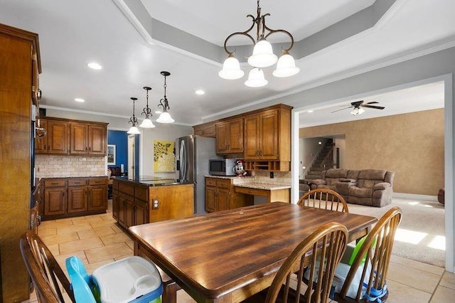 17699 157th Ter, Basehor, KS 66007 - dining space with crown molding, light tile patterned floors, recessed lighting, ceiling fan, and a chandelier