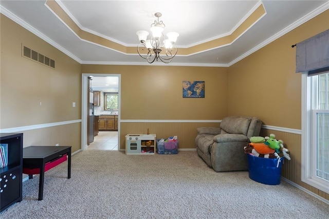 17699 157th Ter, Basehor, KS 66007 - sitting room featuring a wainscoted wall, a chandelier, carpet floors, crown molding, and a raised ceiling