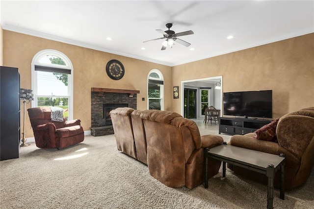 17699 157th Ter, Basehor, KS 66007 - living room with ceiling fan, recessed lighting, carpet, a stone fireplace, and ornamental molding