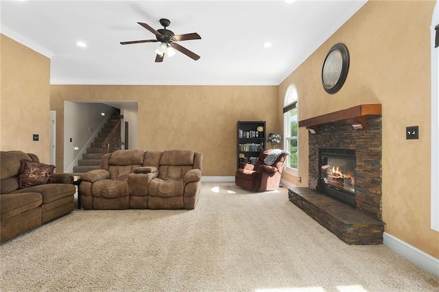 17699 157th Ter, Basehor, KS 66007 - carpeted living room featuring baseboards, crown molding, stairway, ceiling fan, and a stone fireplace