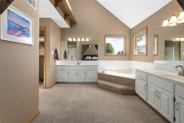 17699 157th Ter, Basehor, KS 66007 - full bathroom featuring two vanities, lofted ceiling, and a bath