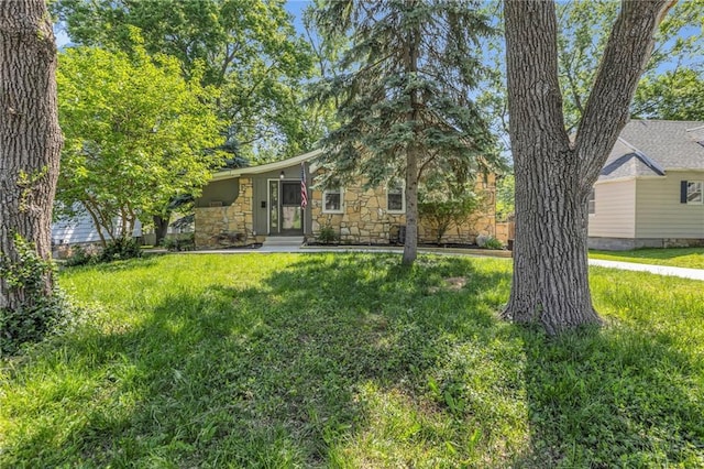view of front facade featuring stone siding and a front yard