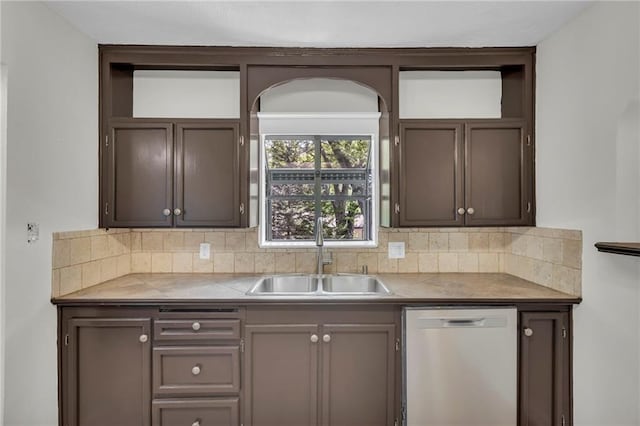 kitchen featuring dishwashing machine, a sink, tasteful backsplash, tile countertops, and open shelves