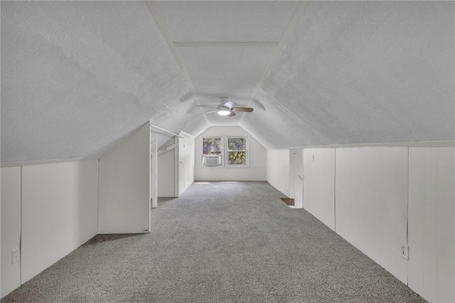 bonus room with carpet flooring, a textured ceiling, lofted ceiling, ceiling fan, and cooling unit