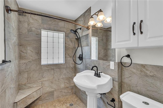 bathroom with tile walls and tiled shower