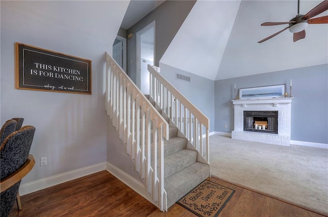 4729 Halsey St, Shawnee, KS 66216 - stairway with a ceiling fan, wood finished floors, lofted ceiling, and a brick fireplace