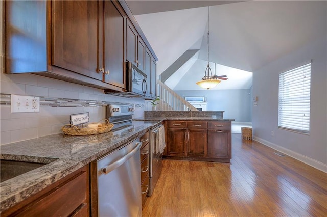 4729 Halsey St, Shawnee, KS 66216 - kitchen with stainless steel appliances, tasteful backsplash, light wood finished floors, dark stone countertops, and vaulted ceiling