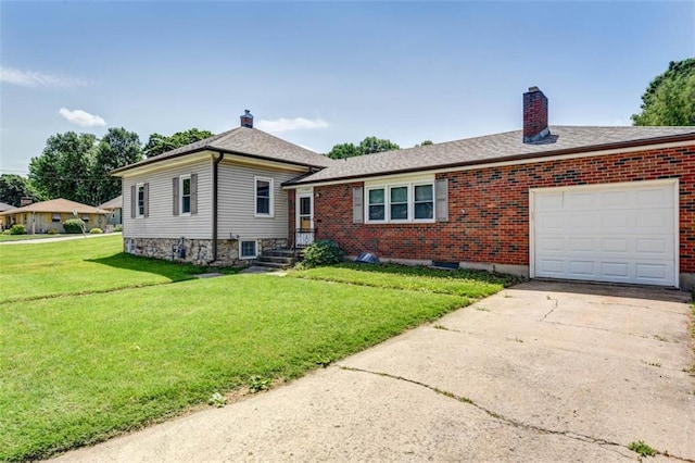 split level home with a garage, a chimney, a front yard, brick siding, and driveway