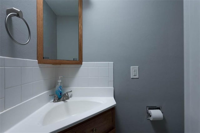 bathroom featuring vanity and backsplash