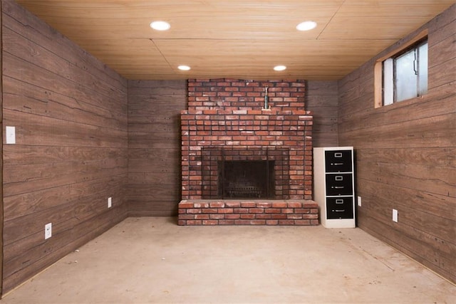 unfurnished living room featuring wooden walls, a fireplace, wooden ceiling, and recessed lighting