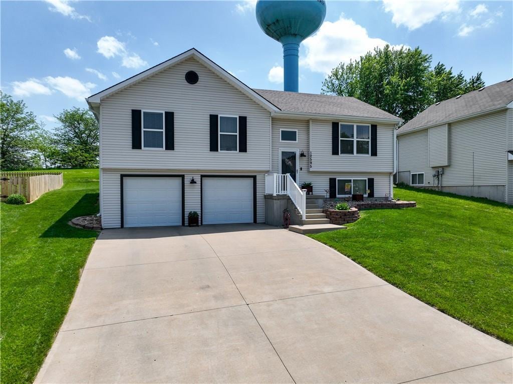 12595 NW Oak Ridge Rd, Platte City, MO 64079 - bi-level home featuring a garage and concrete driveway