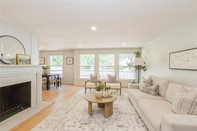 5008 W 79th St, Prairie Village, KS 66208 - living room featuring light wood-style flooring, a fireplace, recessed lighting, baseboards, and crown molding