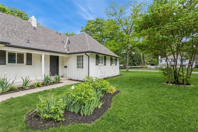 5008 W 79th St, Prairie Village, KS 66208 - view of home's exterior with board and batten siding, roof with shingles, a lawn, a chimney, and brick siding