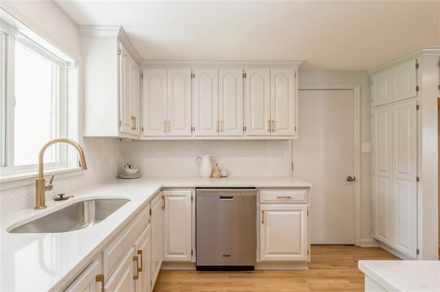 5008 W 79th St, Prairie Village, KS 66208 - kitchen featuring stainless steel dishwasher, a sink, decorative backsplash, and light wood finished floors