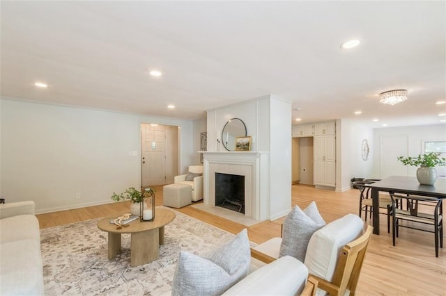 5008 W 79th St, Prairie Village, KS 66208 - living area with recessed lighting, a fireplace with flush hearth, light wood-style flooring, and baseboards