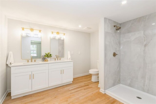 5008 W 79th St, Prairie Village, KS 66208 - bathroom featuring toilet, double vanity, a shower, wood finished floors, and recessed lighting