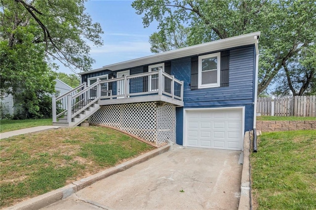 835 N 83rd Dr, Kansas City, KS 66112 - view of front of home featuring a garage, driveway, and a deck